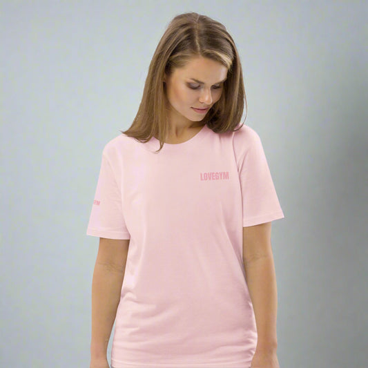 Woman wearing a pink t-shirt with text on a white background